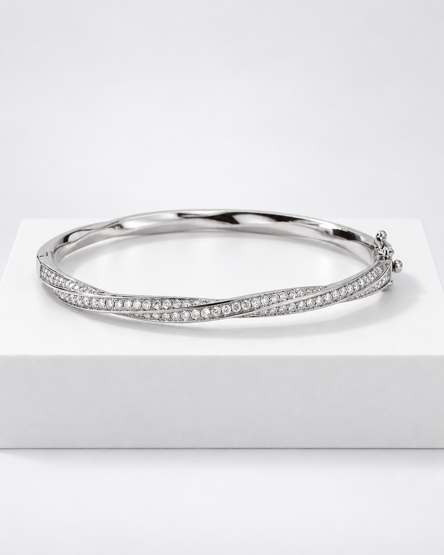 Marlowe bangle, a silver hinged bangle with a continuous twist of pavé stones set edge to edge.