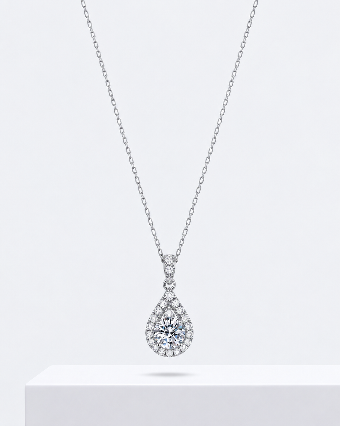 Amora heart pendant, an open heart necklace outlined in stones, on a fine chain.