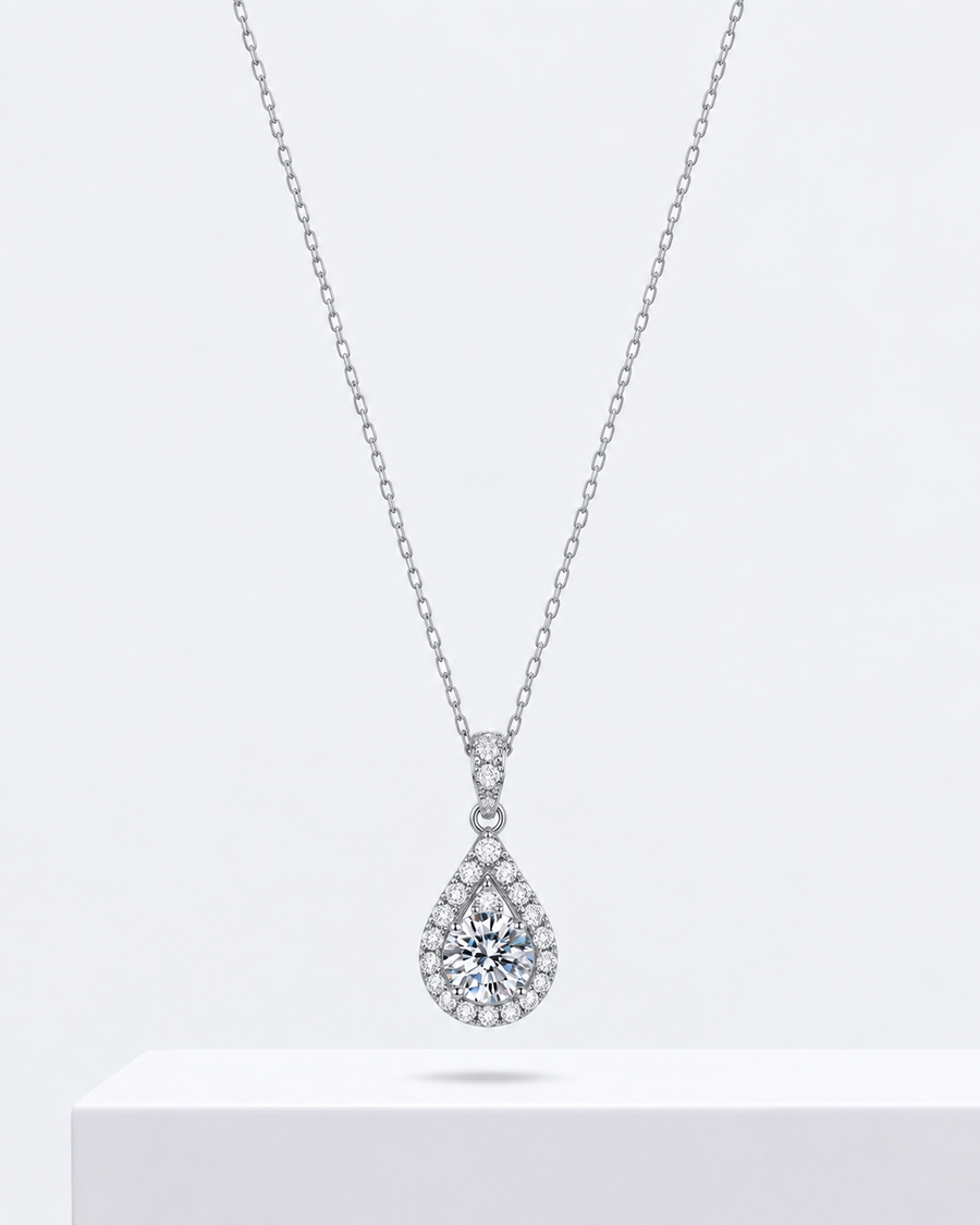 Amora heart pendant, an open heart necklace outlined in stones, on a fine chain.